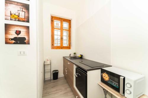 a kitchen with a microwave and a counter top at SUITE INALPI ARENA STADIO OLIMPICO TORINO in Turin
