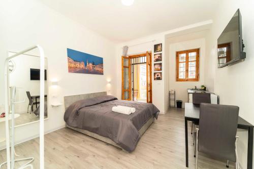 a bedroom with a bed and a desk at SUITE INALPI ARENA STADIO OLIMPICO TORINO in Turin