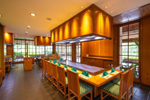 a large dining room with a long table and chairs at Ayodya Resort Bali in Nusa Dua