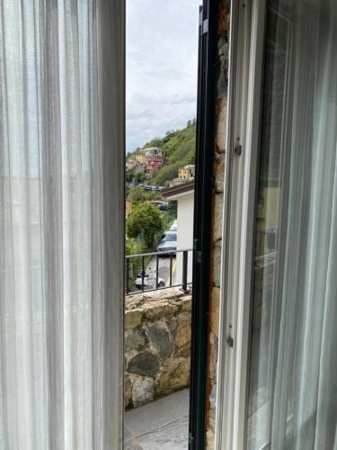 an open window with a view of a balcony at Estate Riomaggiore in Riomaggiore