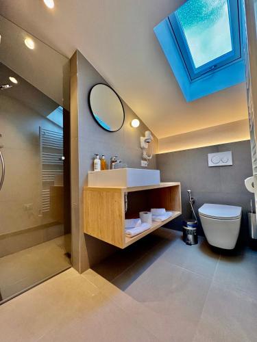 a bathroom with a sink and a toilet and a mirror at Apartment Steinach in Lagundo