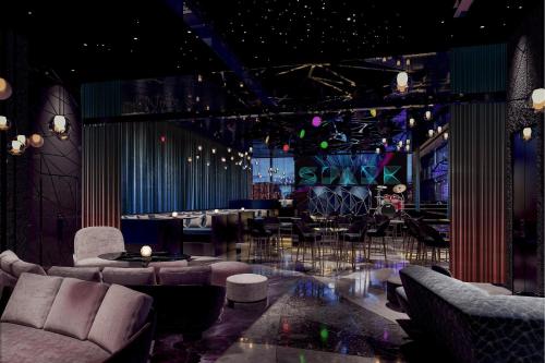 a lobby with couches and a bar in a room at W Chengdu in Chengdu