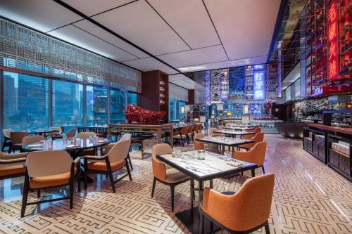 a restaurant with tables and chairs and windows at W Chengdu in Chengdu