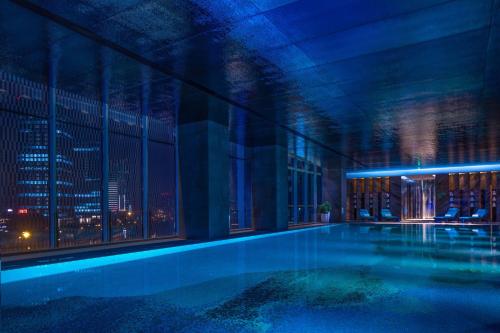a swimming pool in a building with a city skyline at W Chengdu in Chengdu