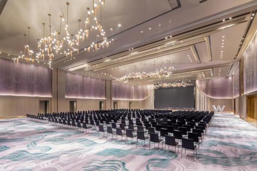 an empty hall with chairs and chandeliers at W Chengdu in Chengdu