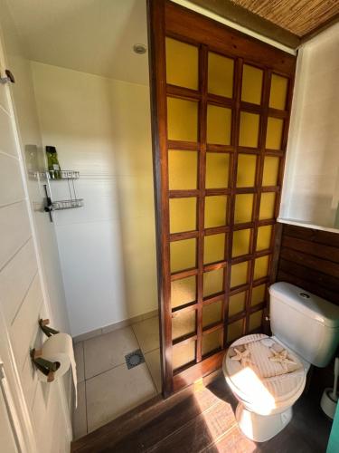 a bathroom with a toilet with a wooden door at Vintage chalet with stunning vieuws in Estepona