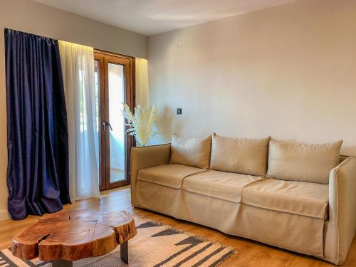 a living room with a couch and a coffee table at Apellou Apartments in Vathý