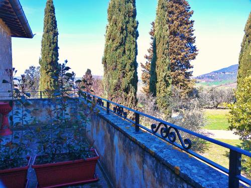 a fence with a bunch of trees behind it at La Collina dei Venti in Gualdo Cattaneo