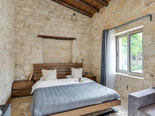 a bedroom with a bed and a stone wall at Sanders Andre Marie in Vasa