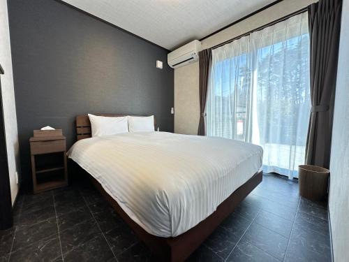 Postel nebo postele na pokoji v ubytování 72 Mt View - B棟 -
