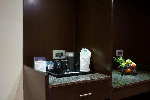 a counter in a hotel room with a coffee maker at Grand Continent Malleshwaram A Sarovar Portico Affiliate Hotel in Bengaluru