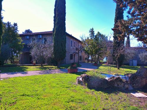 a house with a yard with trees and a building at La Collina dei Venti in Gualdo Cattaneo