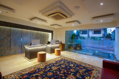 an office with a reception desk and a rug at Grand Continent Malleshwaram A Sarovar Portico Affiliate Hotel in Bangalore