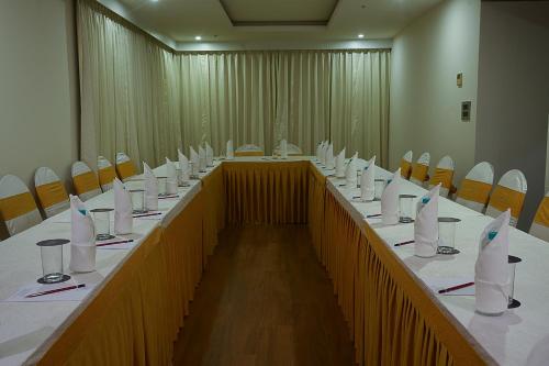 a large conference room with a long table and chairs at Grand Continent Malleshwaram A Sarovar Portico Affiliate Hotel in Bengaluru