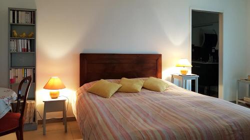 une chambre avec un lit avec deux lampes sur deux tables dans l'établissement Appartement Centre ville Beaux Arts 2 personnes calme et confort, à Montpellier
