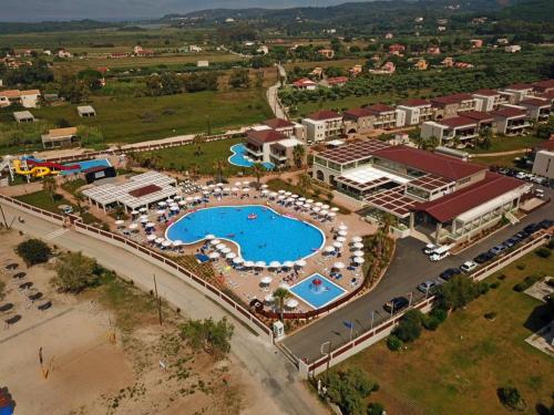 an aerial view of a resort with a pool at Almyros Beach in Acharavi