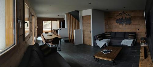 a living room with a couch and a table at Chalet La Gave/La Meije in La Grave