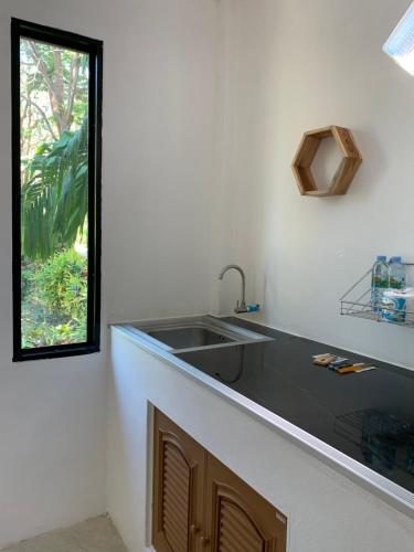 a kitchen with a sink and a window at Spiral Resort in Ko Phayam