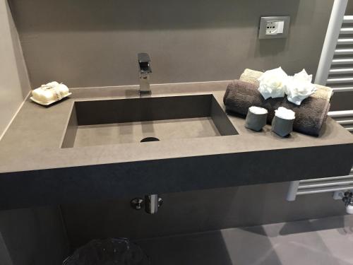 a sink in a bathroom with two towels on a counter at L'Angolino Nascosto in Verona