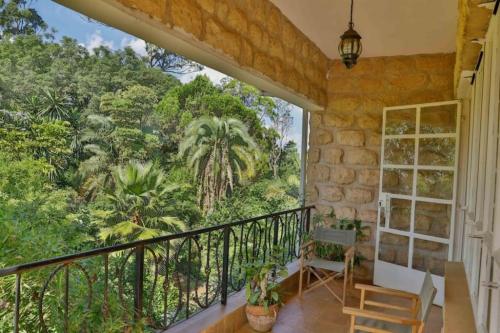 a balcony with a view of the jungle at Zereniti House in Muyaka