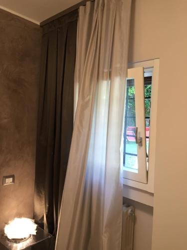 a curtain in a room with a window at L'Angolino Nascosto in Verona