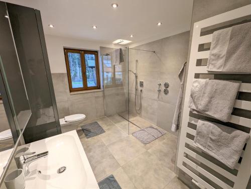 a bathroom with a shower and a sink at Ferienwohnungen Matheisl in Ruhpolding