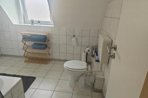 a bathroom with a toilet and a chair in it at 3 room apartment in Eschweiler in Eschweiler