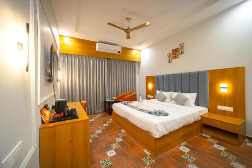a hotel room with a bed and a couch at Gold Nest Rubystone Heritage in Udaipur