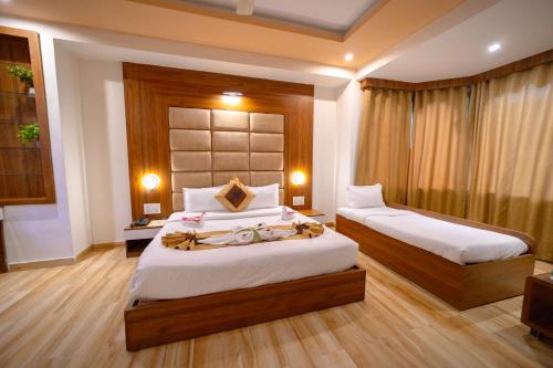 a bedroom with two beds with towels on them at Gold Nest Rubystone Heritage in Udaipur