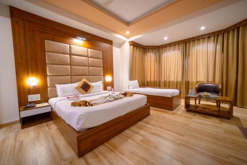 a bedroom with a bed and a desk and a chair at Gold Nest Rubystone Heritage in Udaipur