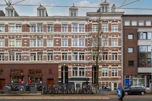 a large brick building with bikes parked in front of it at Numa Amsterdam Oosterpark in Amsterdam