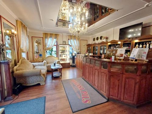 ユールマラにあるPegasa Pils Spa Hotelのソファと椅子のある店内のバー