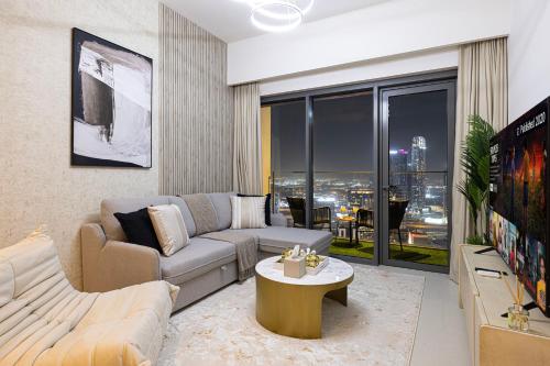 a living room with a couch and a table at SmartStay at Burj Royale - Full Burj Khalifa View - Brand New Luxury Apartments in Dubai