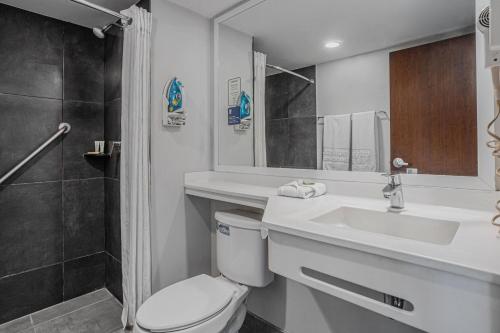 a bathroom with a toilet and a sink and a shower at City Express by Marriott Durango in Durango