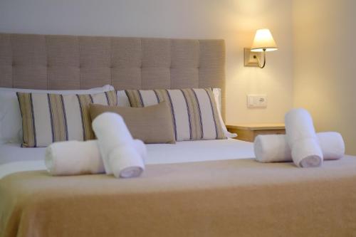 a bedroom with a large bed with white pillows at La Era de Casaus in Gavín