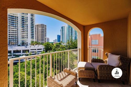 a balcony with chairs and a view of a city at Bnb Hyperion - Family-Friendly! 3BR, 2BA, Balcony in Miami
