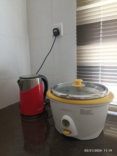 a food processor sitting on a counter next to a cup at Casa Margosa Homestay in Ipoh