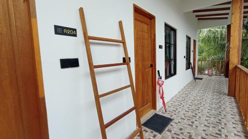 a ladder leaning against a wall next to a door at Ahiva Village in Fulhadhoo