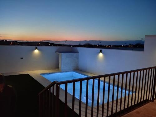 a swimming pool on top of a building at night at Casa de Goya in Argés