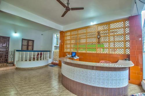 a lobby with a counter in the middle of a room at Candolim beach touch flats in Candolim