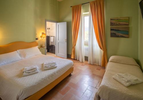 a bedroom with two towels sitting on a bed at B&B Porta Perugina in Bevagna