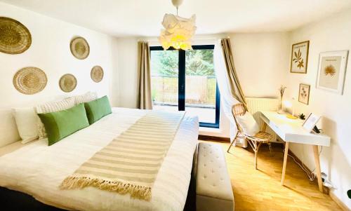a bedroom with a large bed with a desk and a window at Appart Brussels Atomium&Expo in Grimbergen