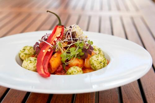 a white plate of food on a table at Seewirt & Haus Attila in Podersdorf am See