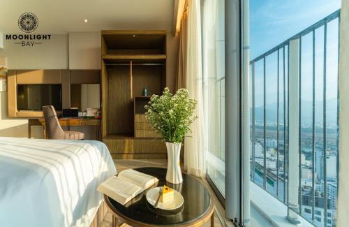 a hotel room with a bed and a large window at Moonlight Bay Panorama Condotel Ocean View in Nha Trang