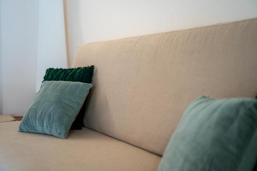 a couch with two pillows sitting on it at El Secreto de Chirinos in Úbeda