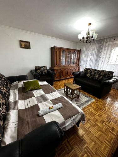 a living room with a bed and a couch at TAMARIS Apartment in Subotica