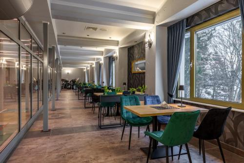 a row of tables and chairs in a restaurant at DW Atrium in Polańczyk