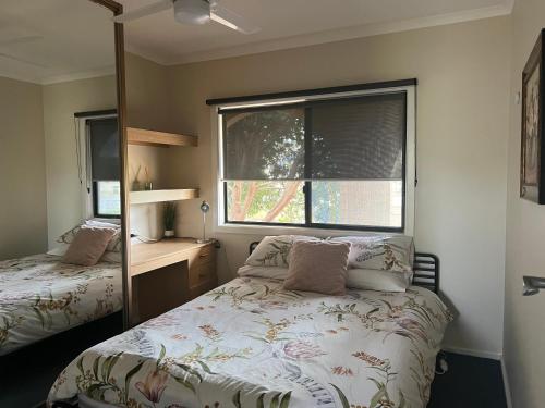 a small bedroom with a bed and a window at Shazza’s Desert Oasis in Broken Hill