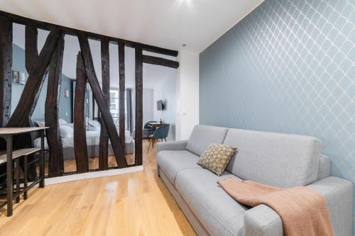 - un salon avec un canapé et une chambre dans l'établissement Imhost 7 -Cosy apart Batignolles/Galerie Lafayette, à Paris