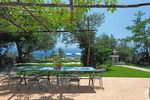 a table and chairs with a view of the ocean at Villa Borgo San Michele in Amalfi